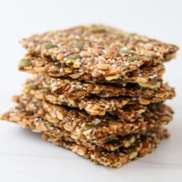 Close up of a stack of gluten-free seed crackers (Norwegian Crispbread)