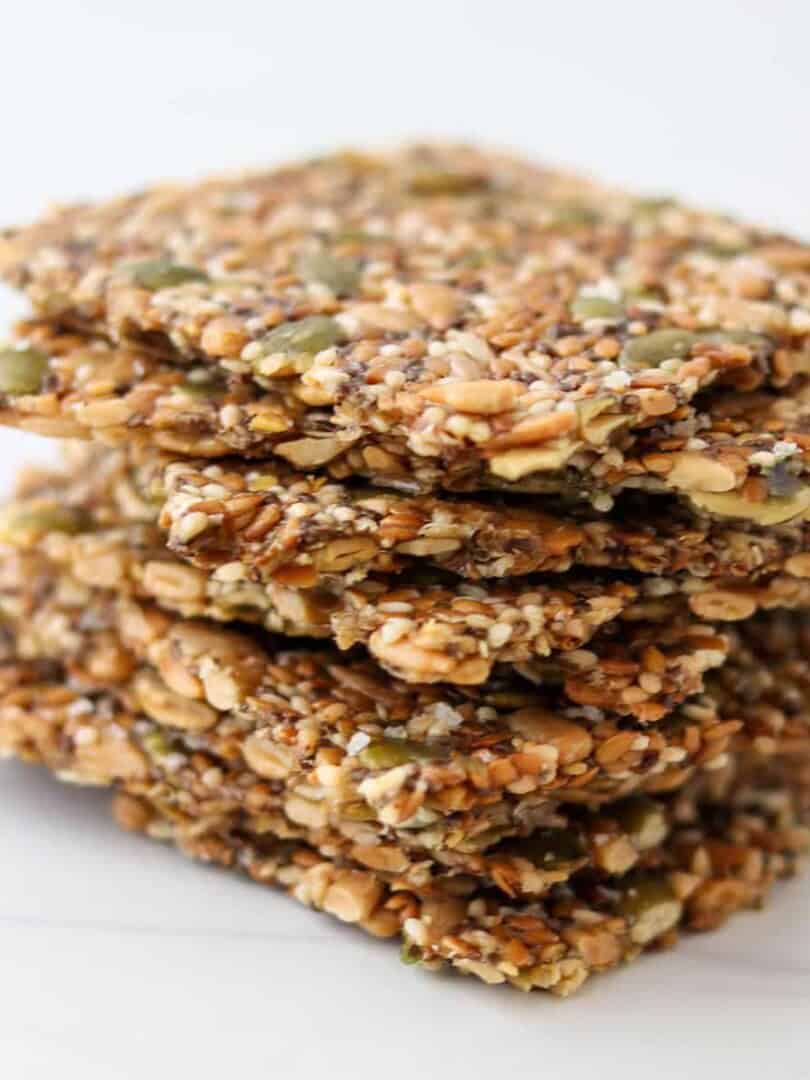 Close up of a stack of gluten-free seed crackers (Norwegian Crispbread)