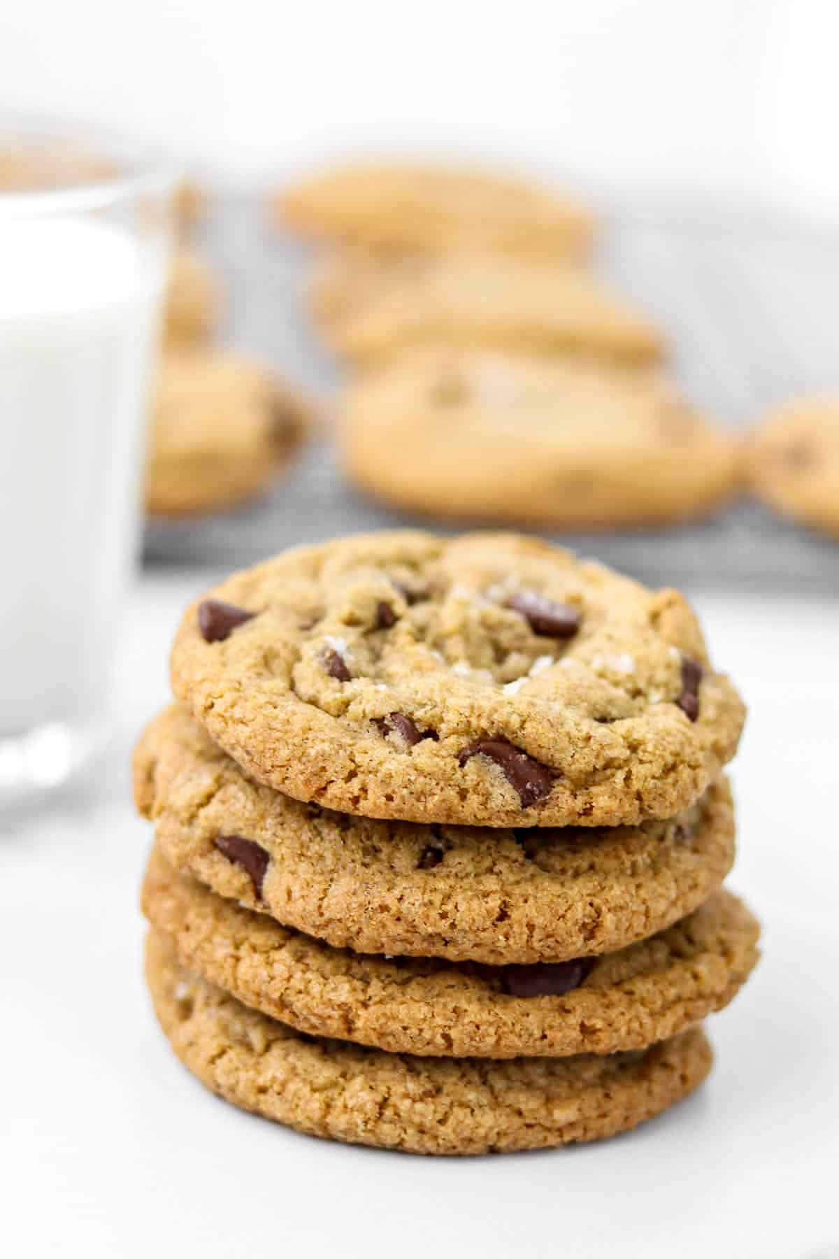 Stack of chocolate cookies next to a glass of milk.
