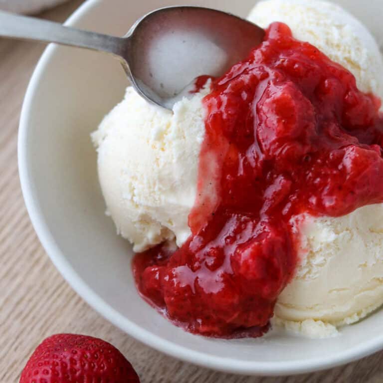 Close up of Strawberry Rhubarb Compote on ice cream.