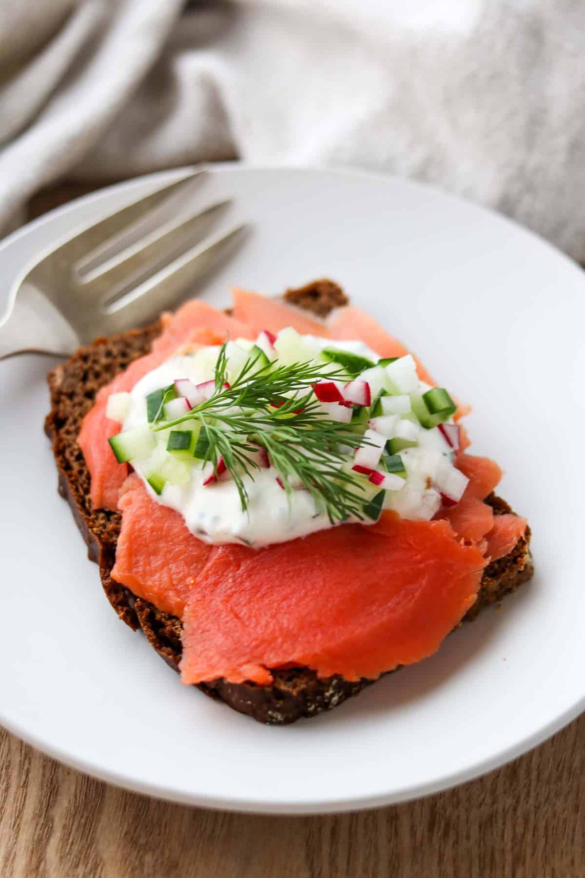 Horseradish Yogurt Sauce on top of a smoked salmon open faced sandwich.