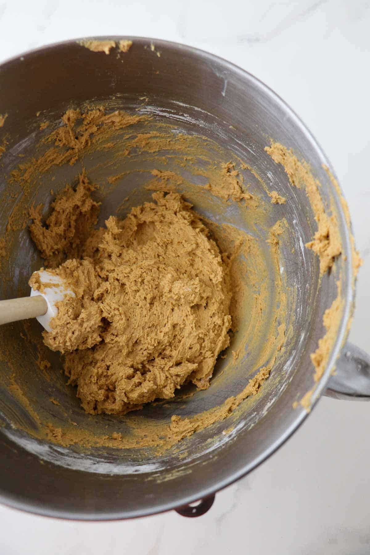 Swedish Ginger Cookie dough in a metal bowl with a rubber spatula.