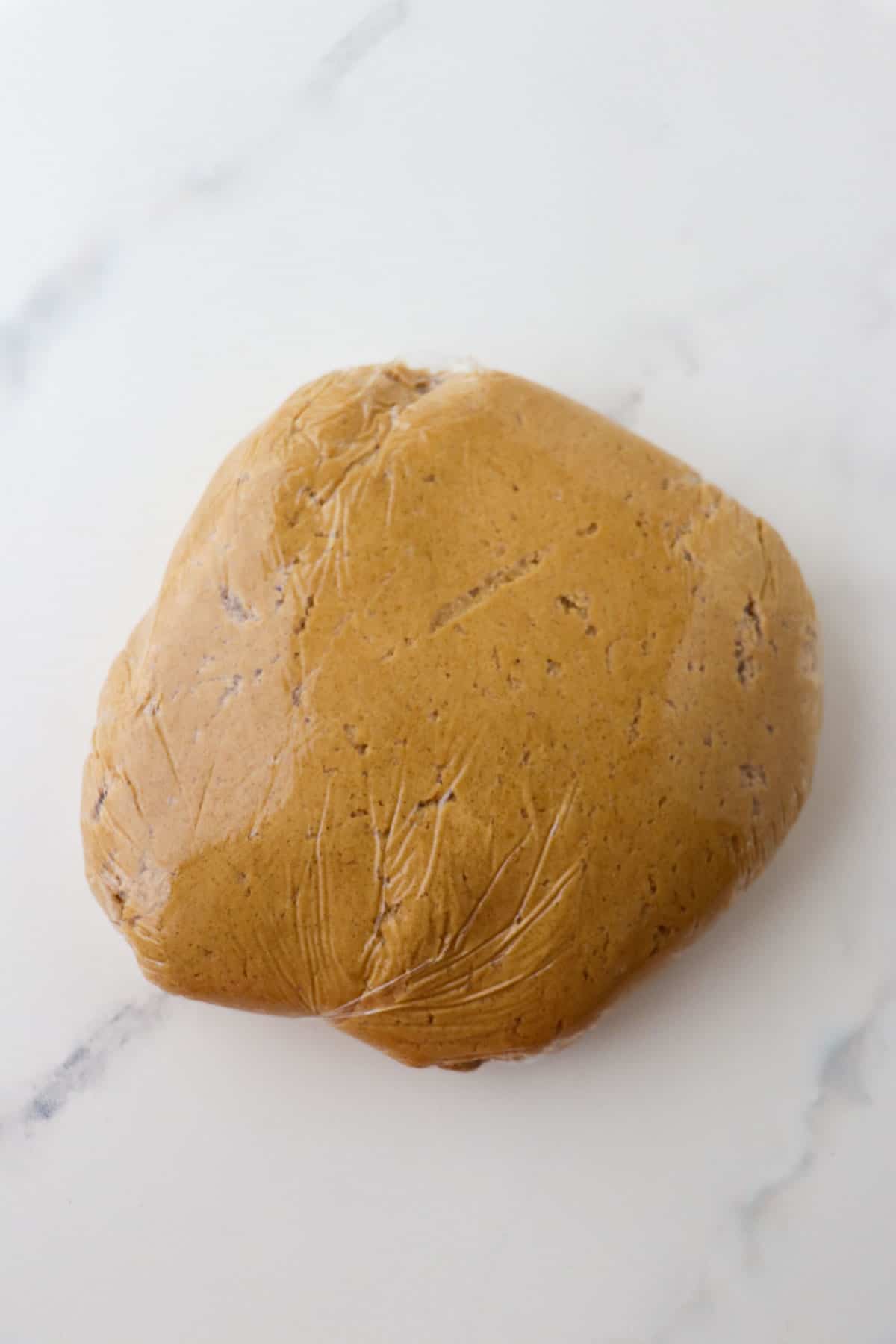 Swedish Ginger Cookie dough wrapped in saran wrap.