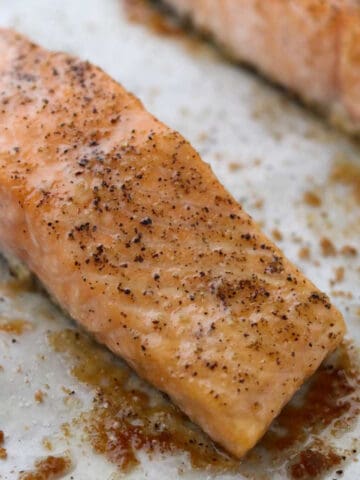 Close up of Baked Salmon with Butter and Brown Sugar on a baking sheet.