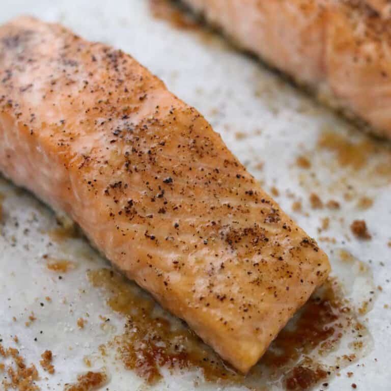 Close up of Baked Salmon with Butter and Brown Sugar on a baking sheet.