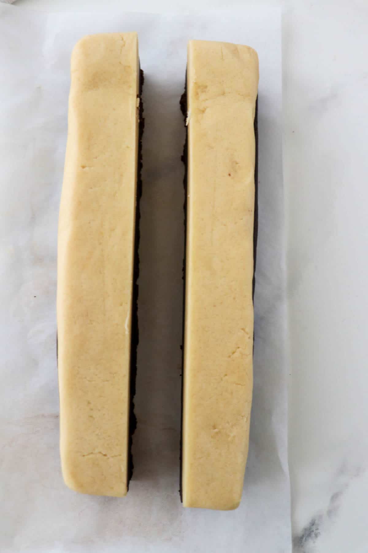 Rectangle of cookie dough cut in half lengthwise.