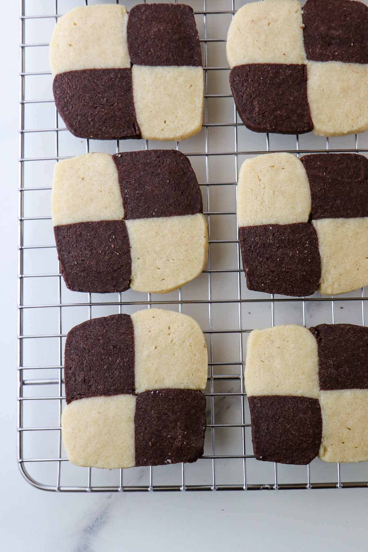 Checkerboard cookies on a metal cooling rack.