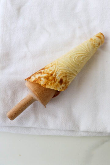 Krumkake rolled around a cone form.