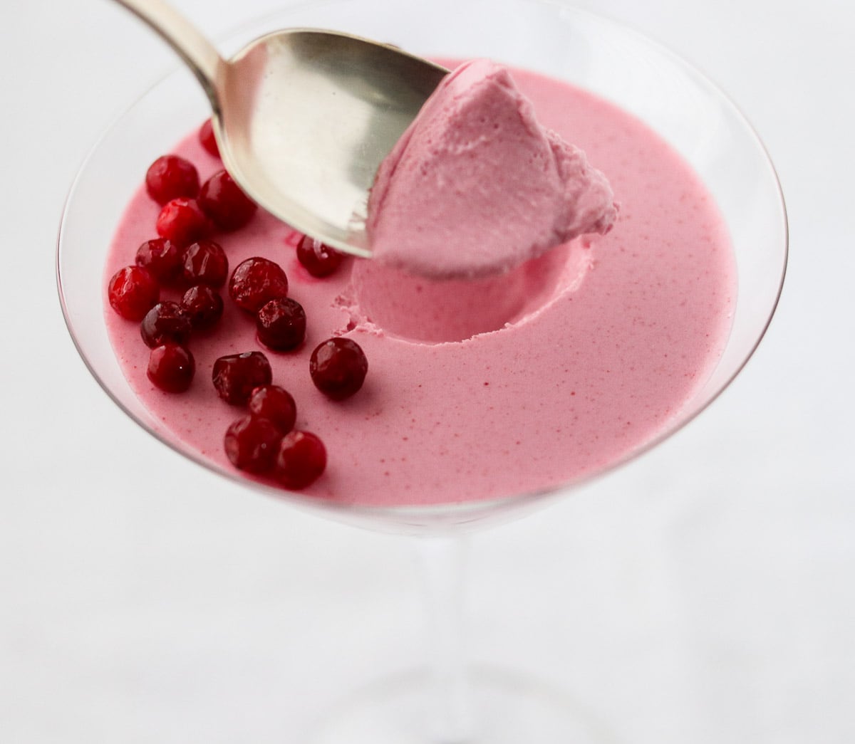 Person taking a spoonful of Lingonberry Mousse (Trollkrem).