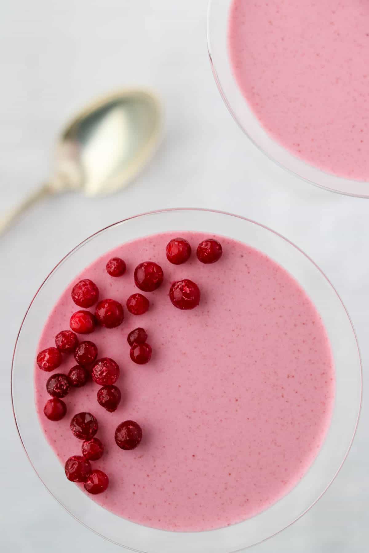 Overhead view of Lingonberry Mousse (Trollkrem) topped with frozen lingonberries.