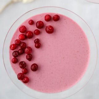 Close up of an overhead shot of Lingonberry Mousse topped with frozen lingonberries.