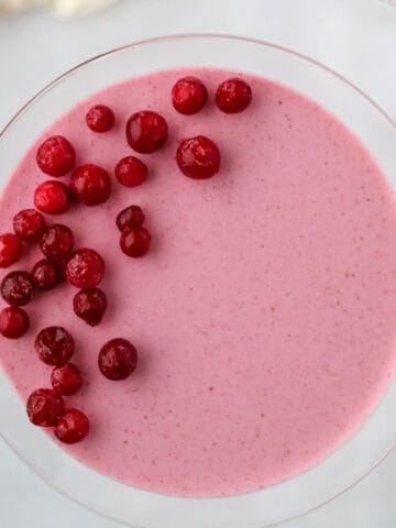 Close up of an overhead shot of Lingonberry Mousse topped with frozen lingonberries.