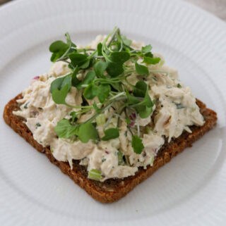 Close up of Chicken Salad Smørrebrød topped with microgreens.