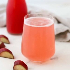 close up of glass of rhubarb syrup (cordial) and sparkling water.