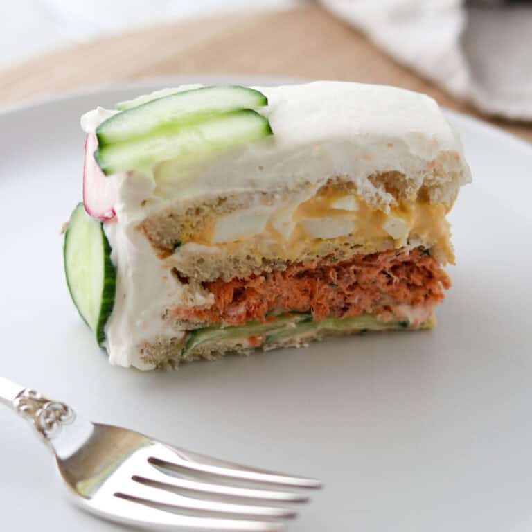 Close up of a slice of Smörgåstårta (Swedish Sandwich Cake).