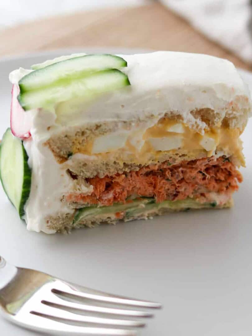 Close up of a slice of Smörgåstårta (Swedish Sandwich Cake).