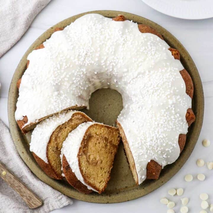 Close up overhead view of White Chocolate Cake with a couple of slices cut.