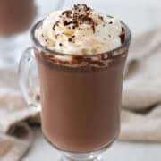 Cardamom Hot Chocolate in a glass mug with whipped cream.