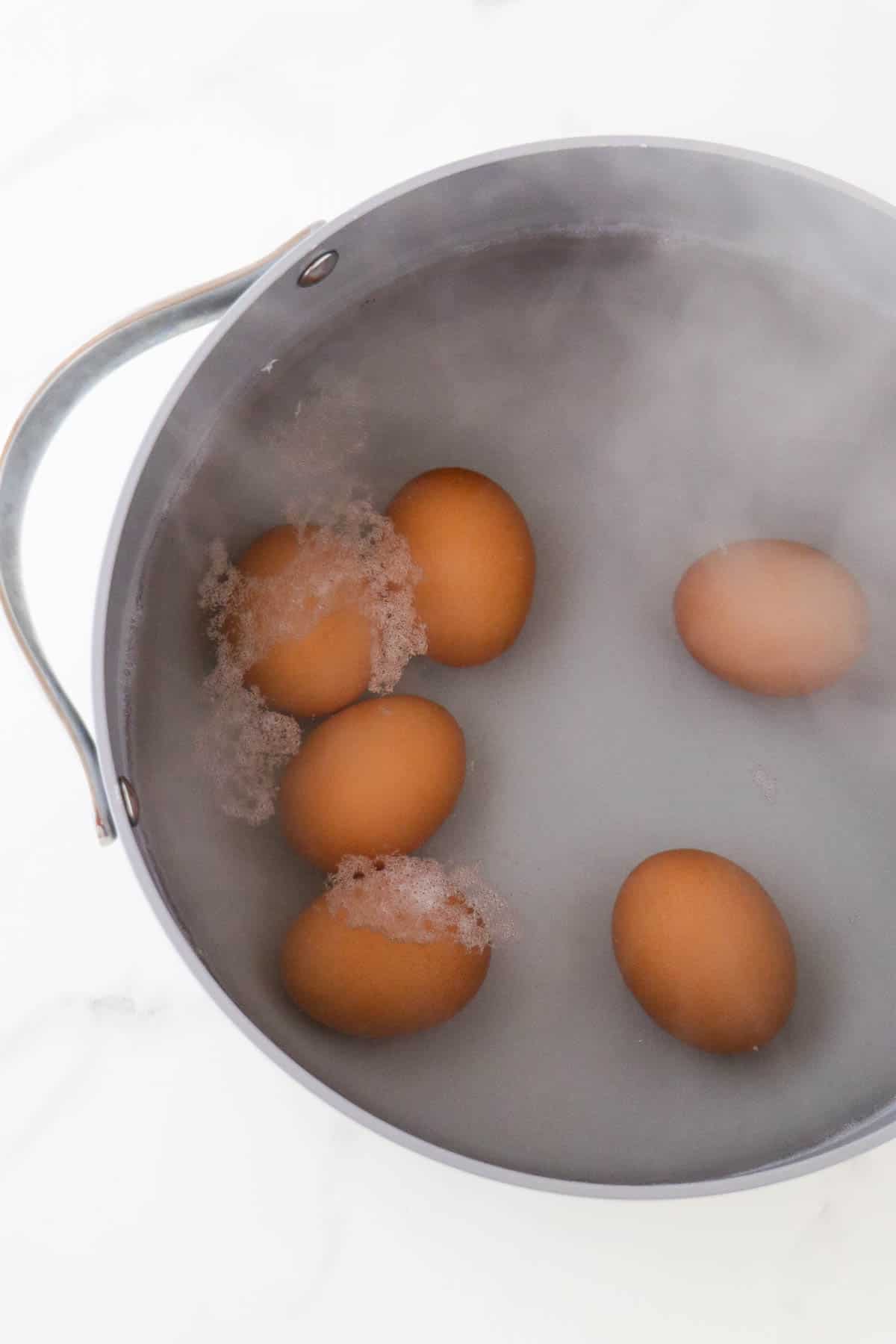 Eggs in a pot with boiling water.