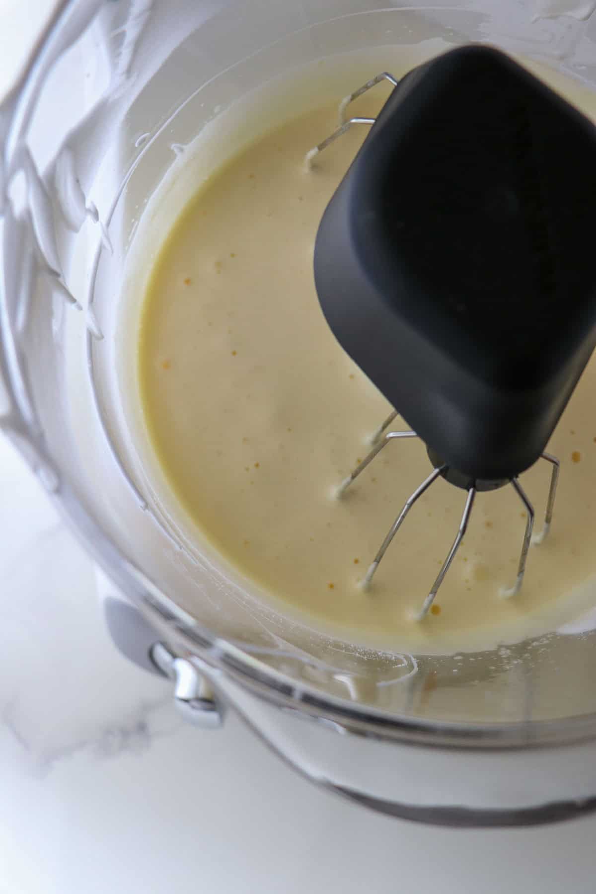 Egg yolks mixed together in a stand mixer.