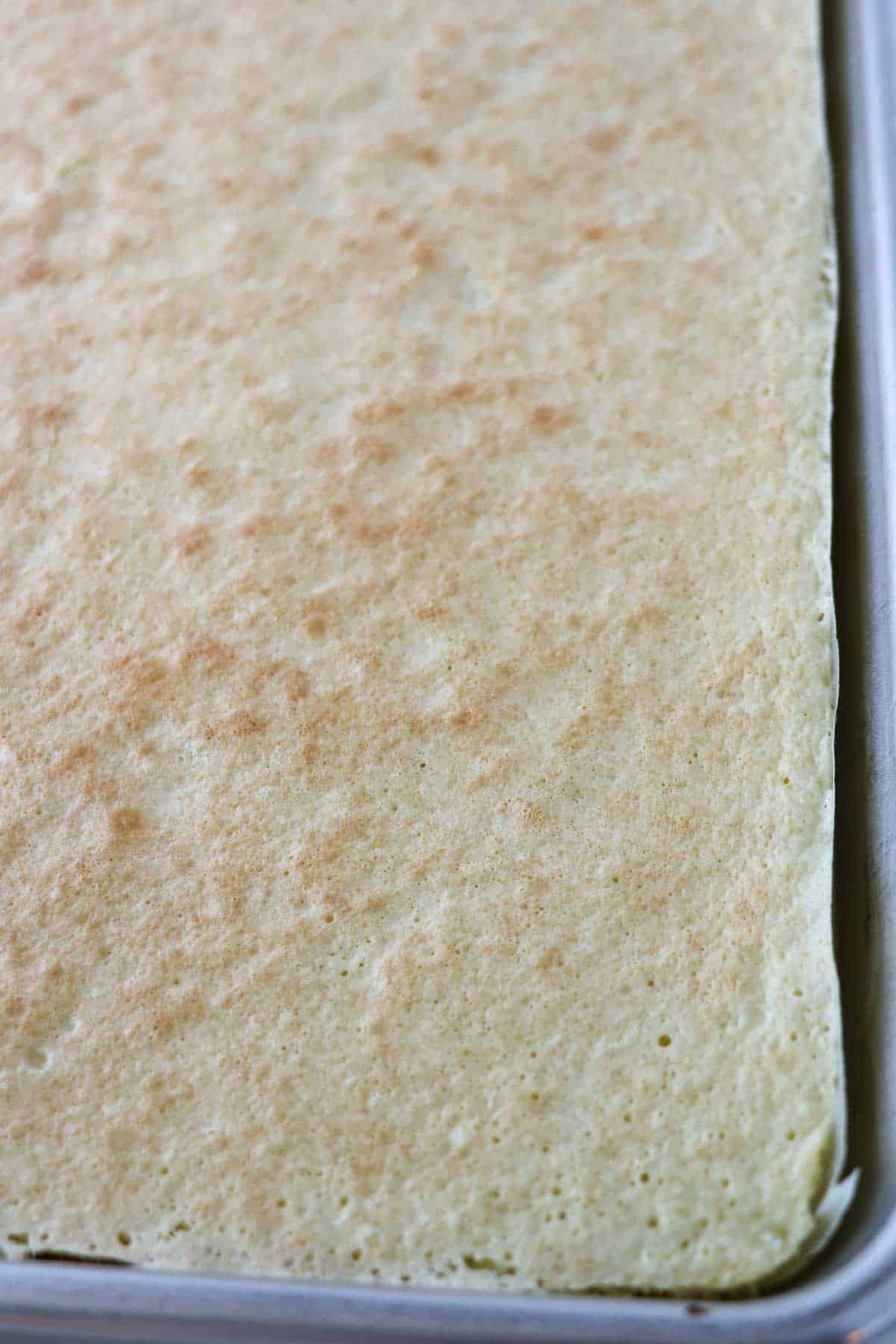 Baked Swedish Rulltårta in a pan.