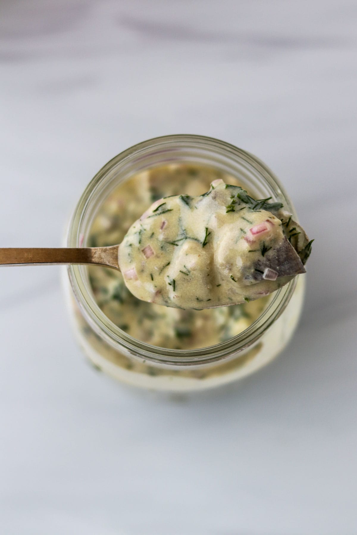 Swedish Mustard Herring on a spoon.