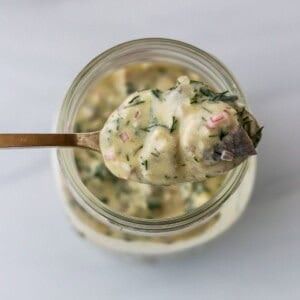 Swedish Mustard Herring on a spoon.