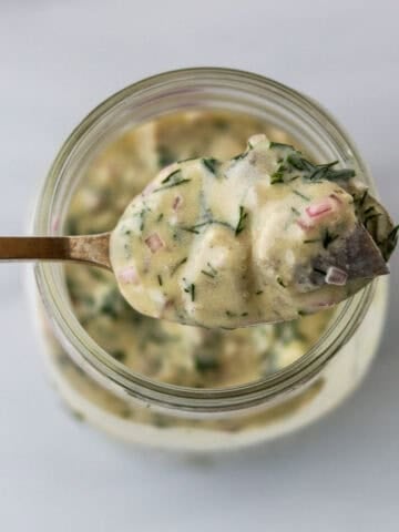 Swedish Mustard Herring on a spoon.