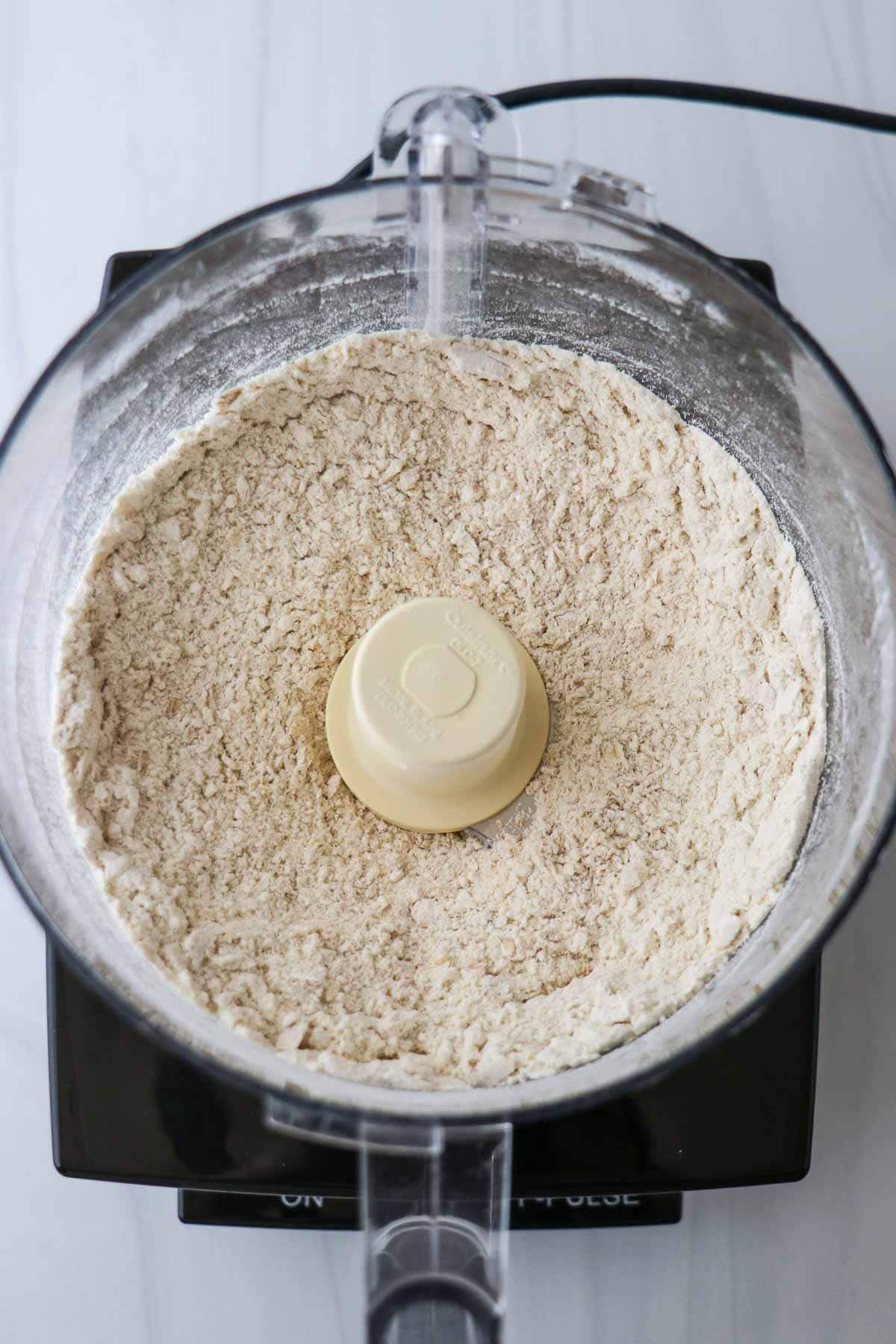 Flour and other dry ingredients in a food processor.