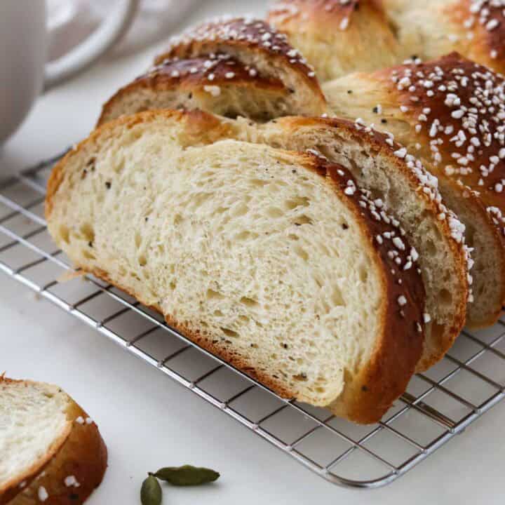 Cardamom Bread sliced on a cooling rack.