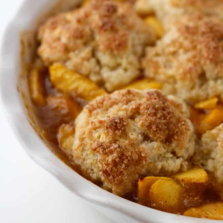 Biscuit on top of peaches in Cardamom Peach Cobbler.