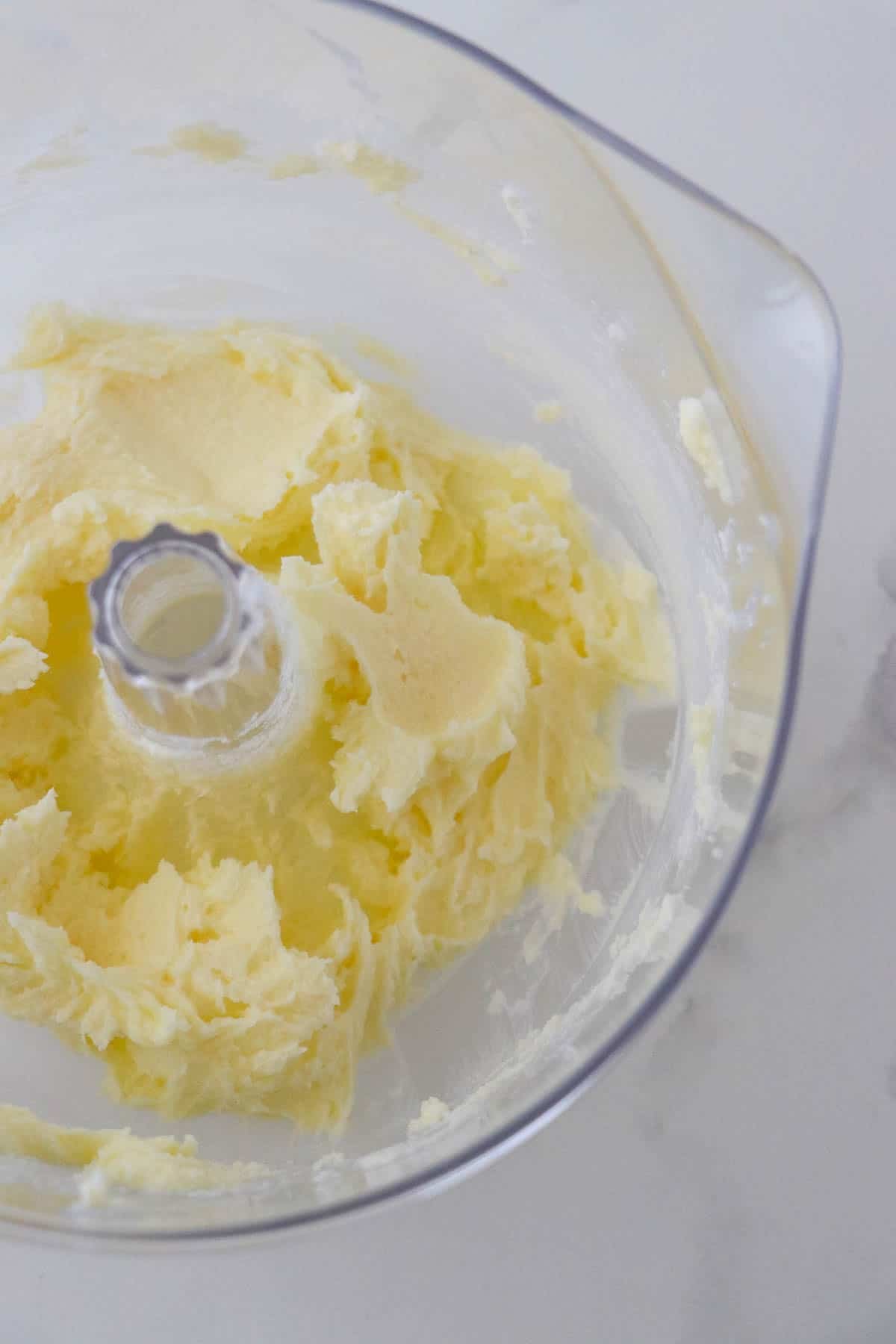 Creamed butter in a clear mixing bowl.