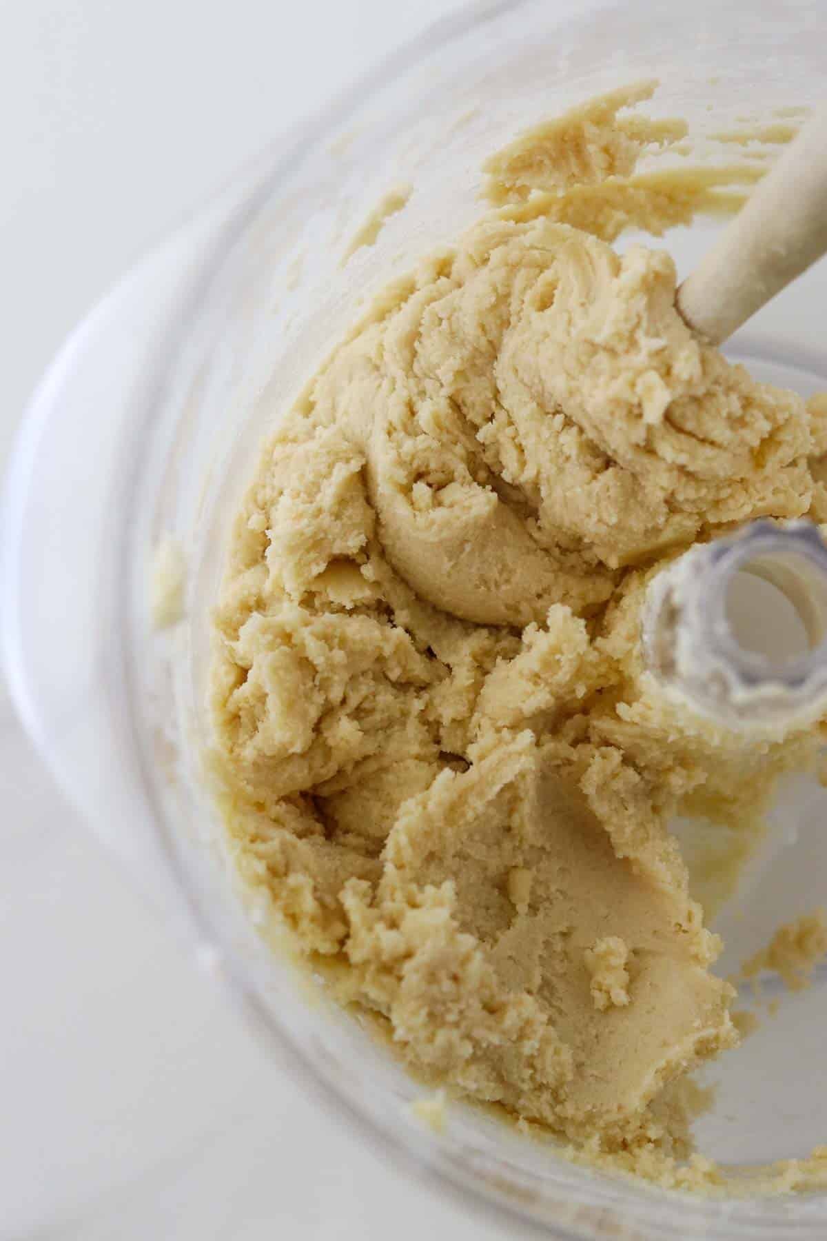 Danish Butter Cookies (Valiljekranse) dough in a mixing bowl with a rubber spatula.