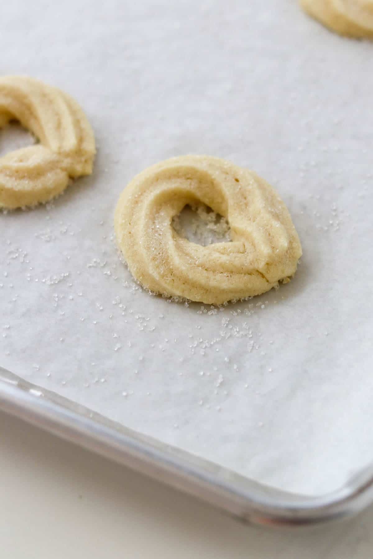 Baked Danish Butter Cookies (Valiljekranse) on a baking sheet.