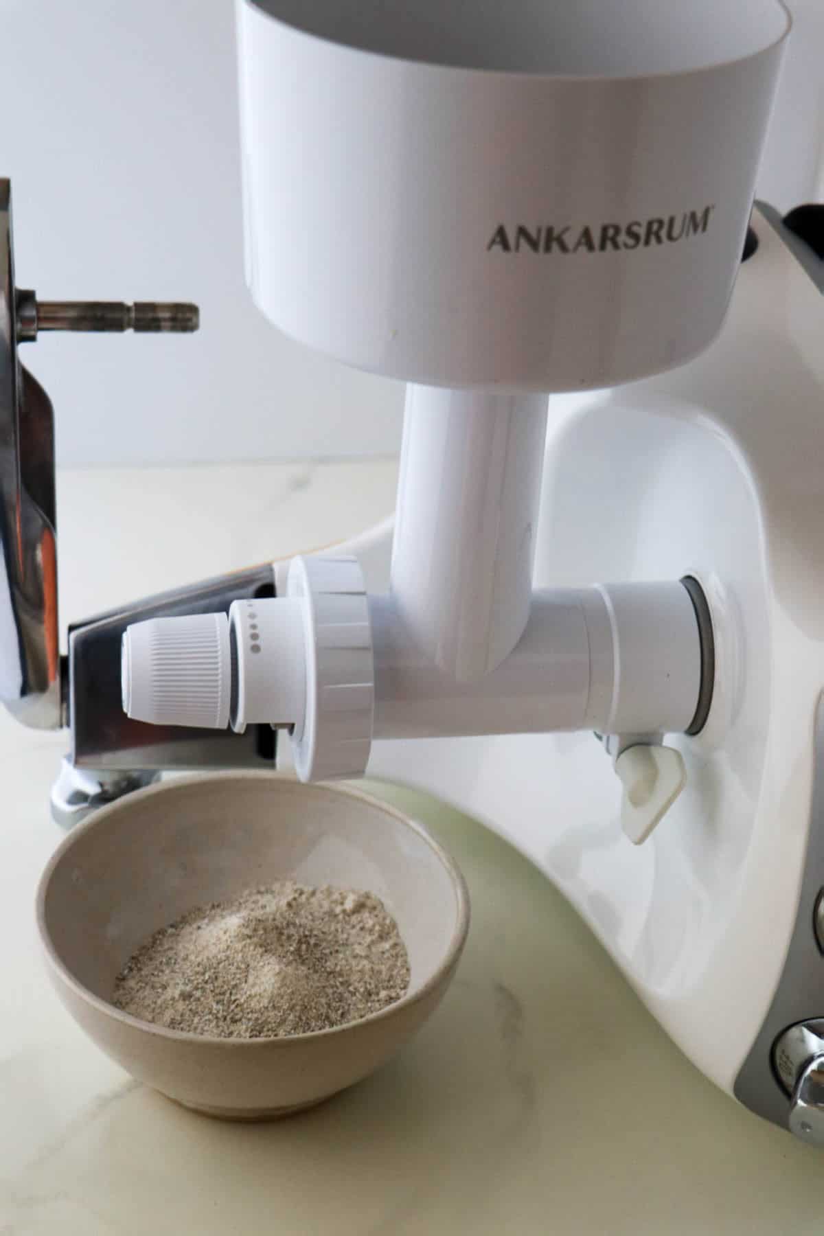 Ankarsrum grain mill attachment and a bowl of rye flour.