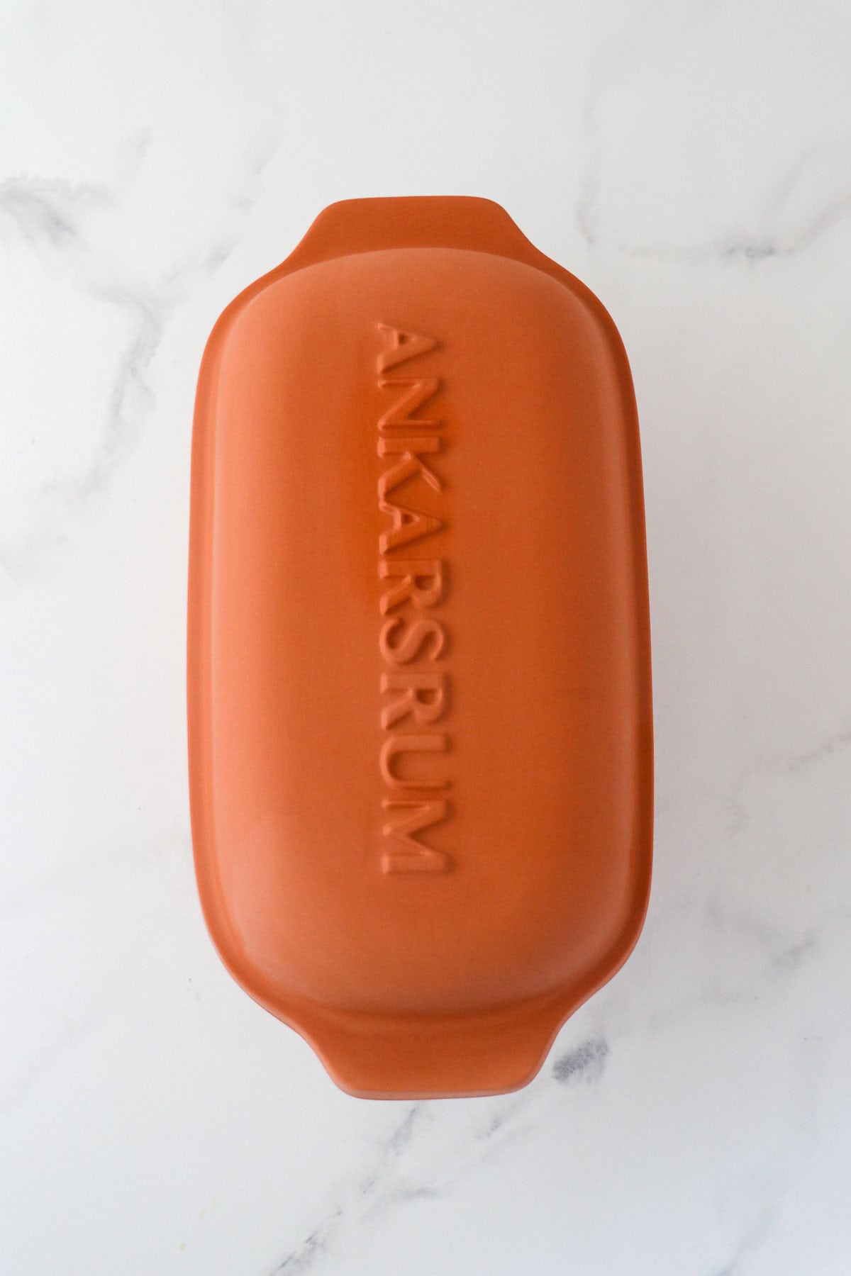 Ankarsrum Clay Baker on a marble surface.