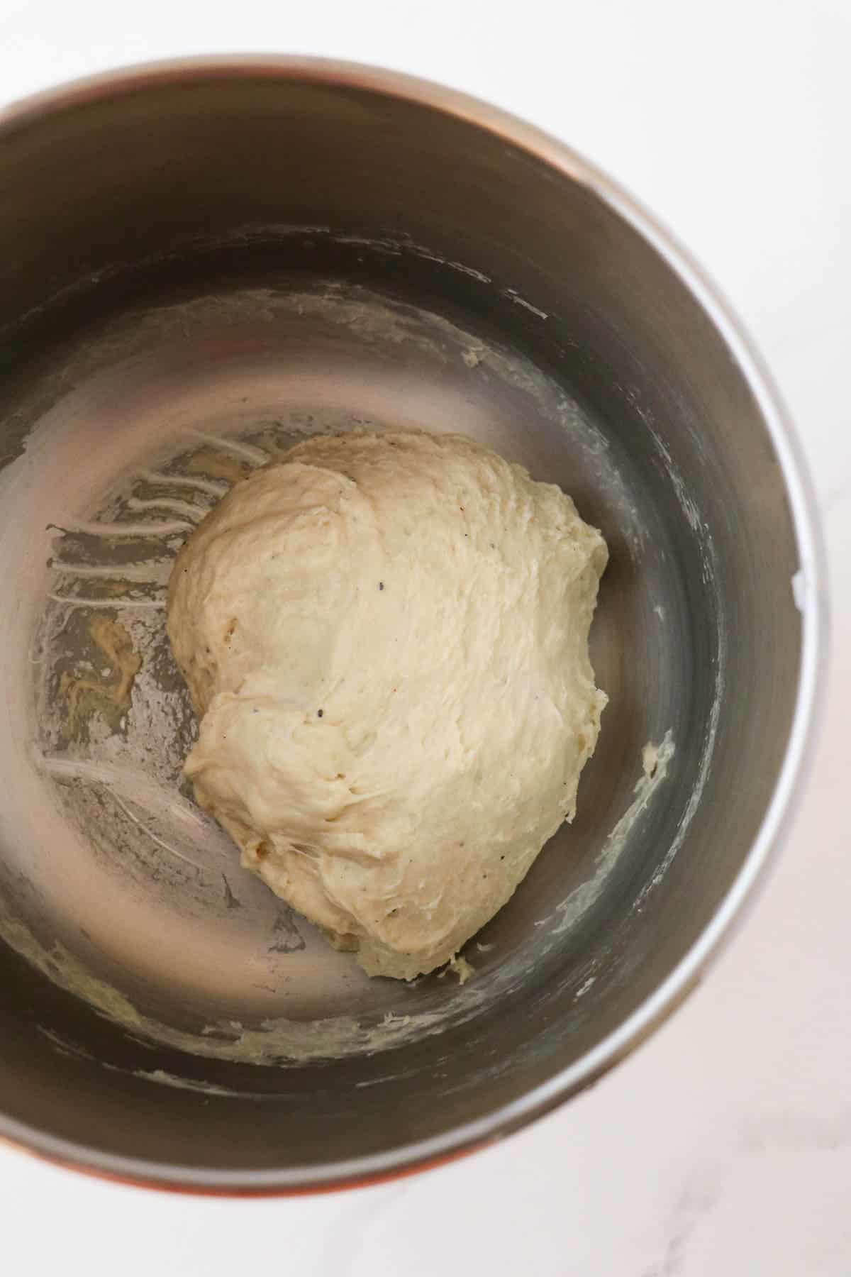 Norwegian Cinnamon Buns (Skillingsboller) dough in a metal bowl prior to proofing.