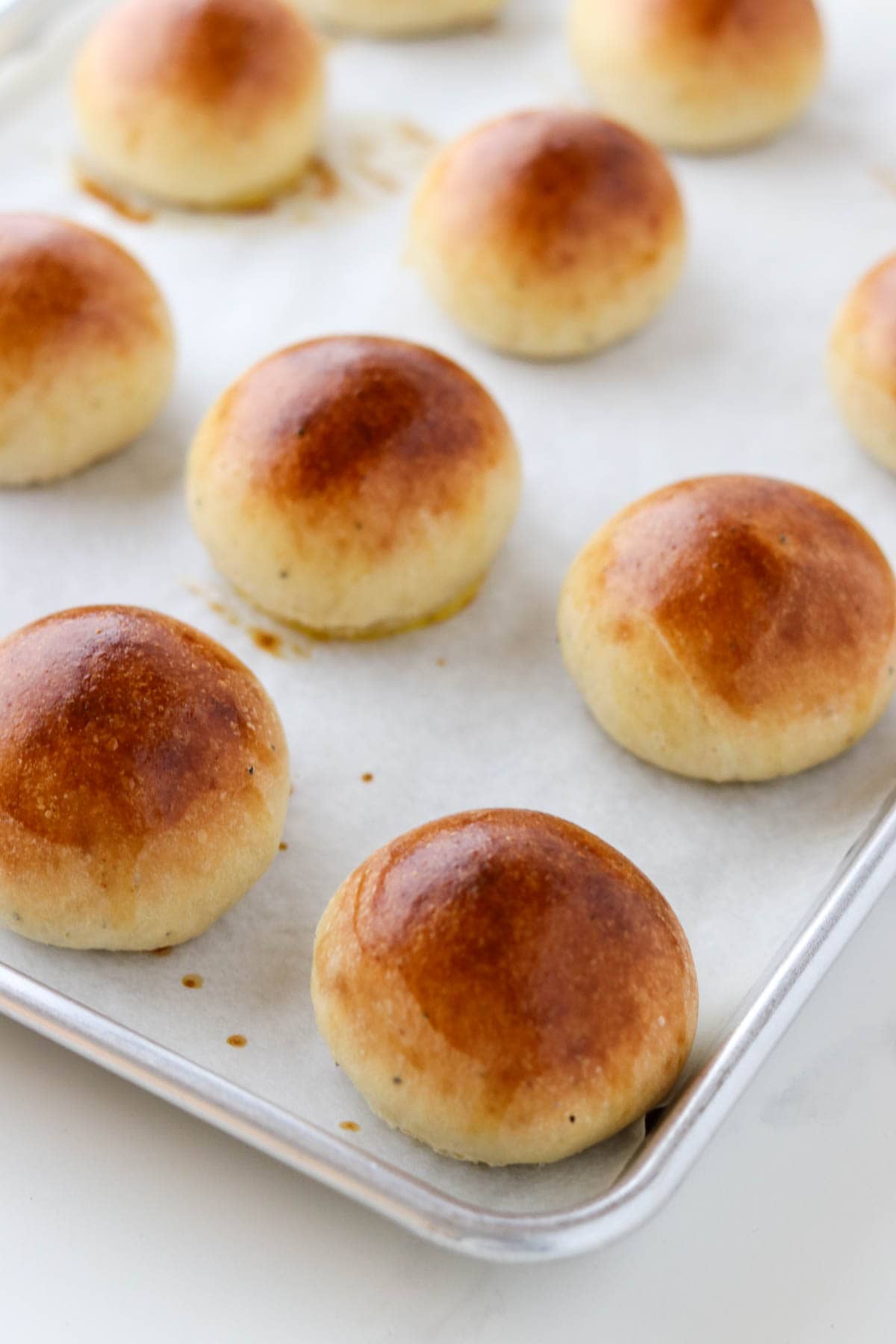 Baked Fastelavnsboller (Norwegian Lenten Buns) on a metal baking sheet.