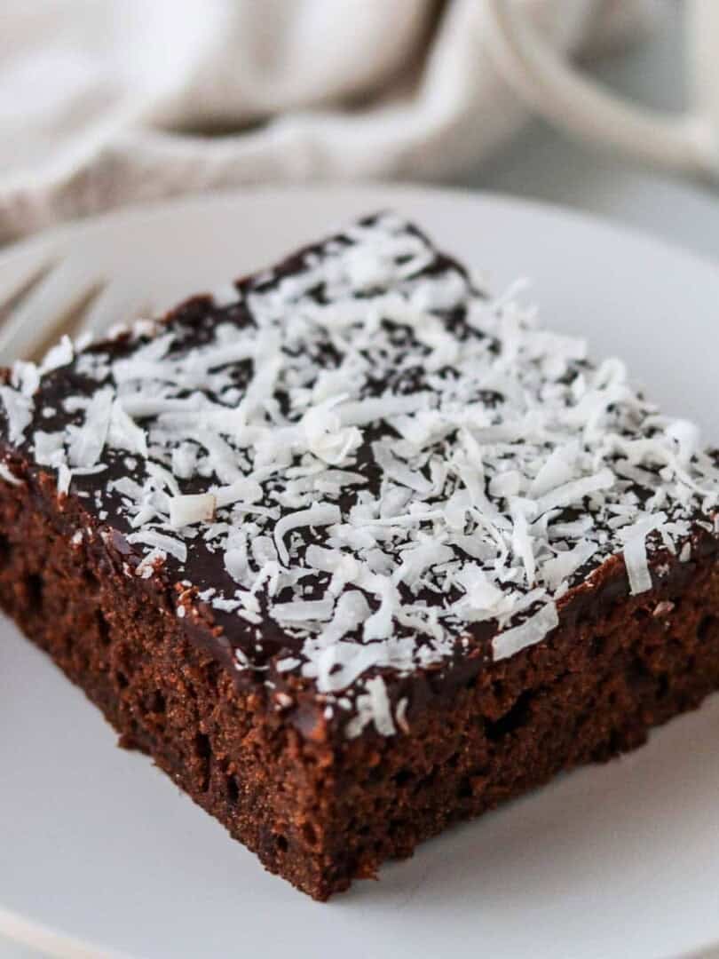 A slice of Swedish Love Cake (Kärleksmums) on a plate with a fork.