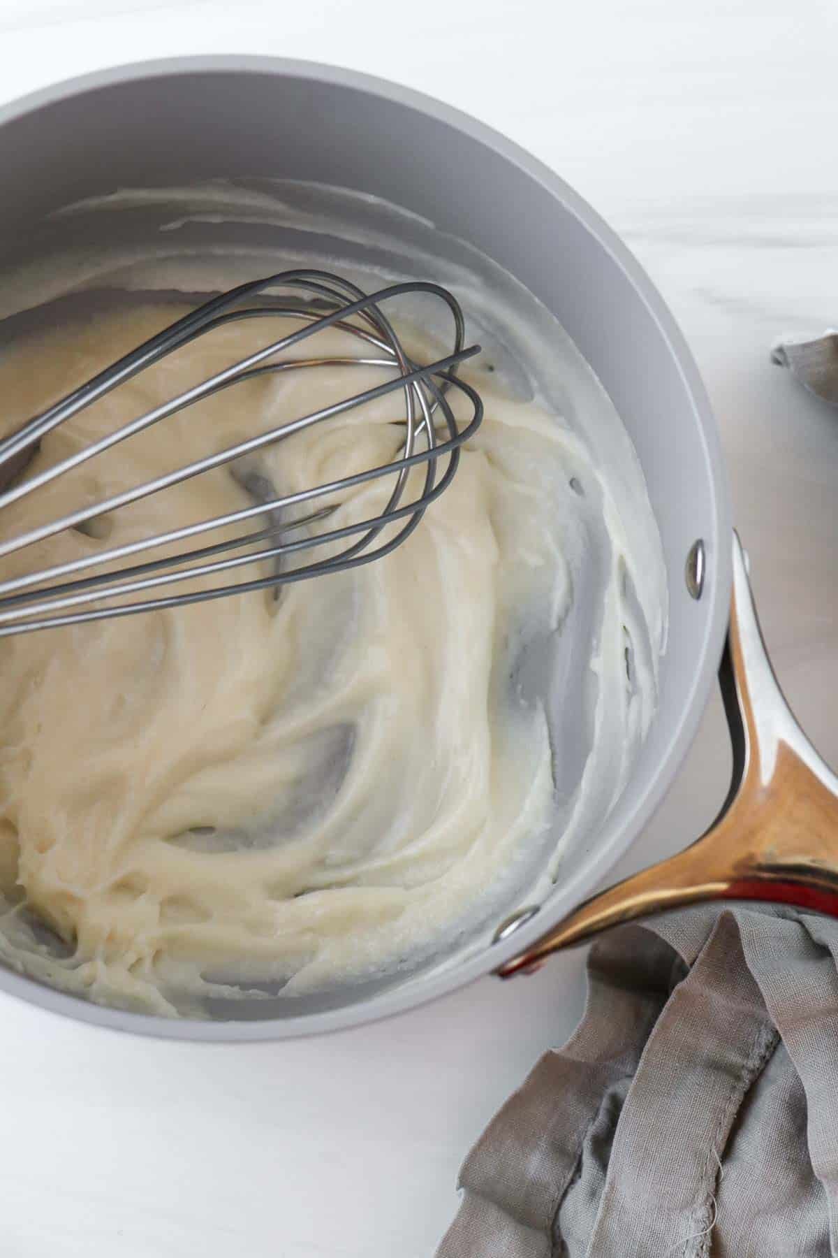 Tangzhong in a saucepan with a whisk.