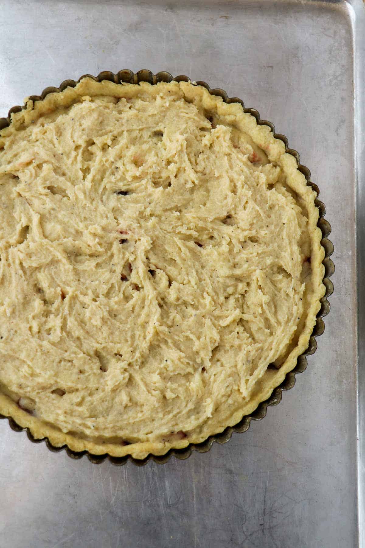 Unbaked Lingonberry Almond Tart topped with almond frangipane.