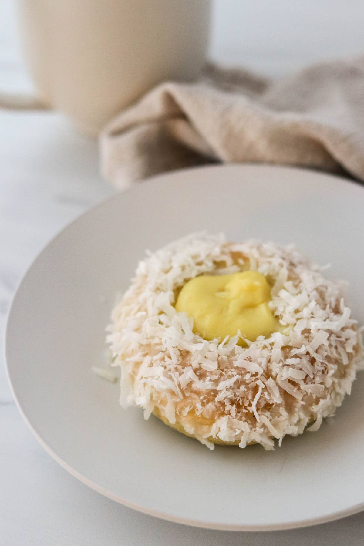 Norwegian Skoleboller on a plate next to a napkin and mug.