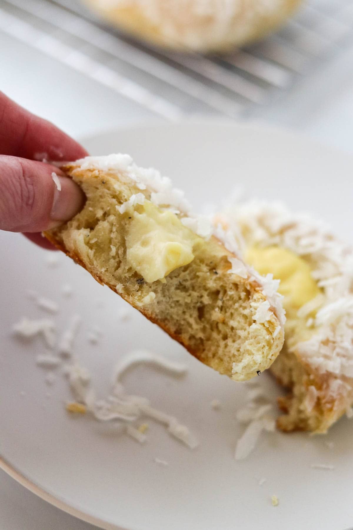 Person holding Norwegian Skoleboller with a bite out of it.