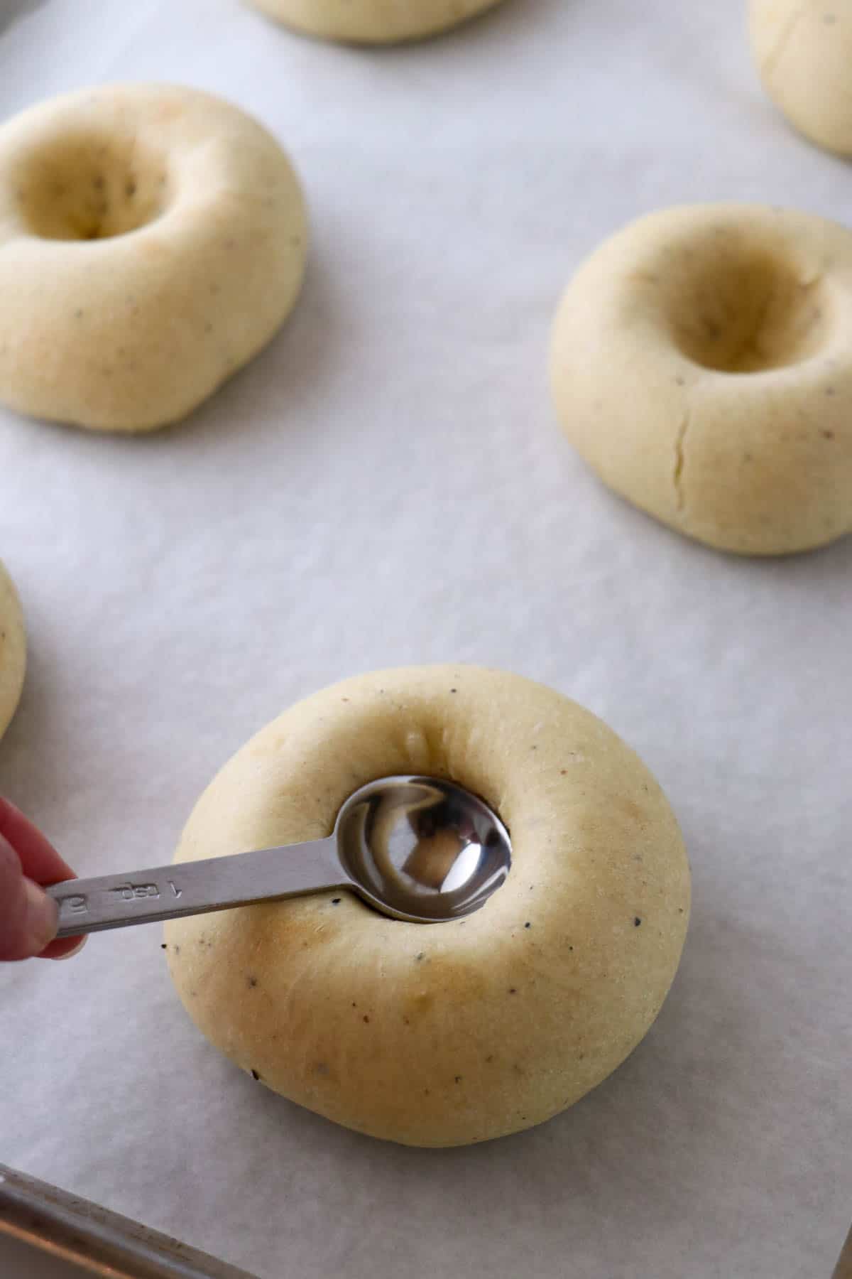 Person pressing down the center of a Norwegian Skoleboller.