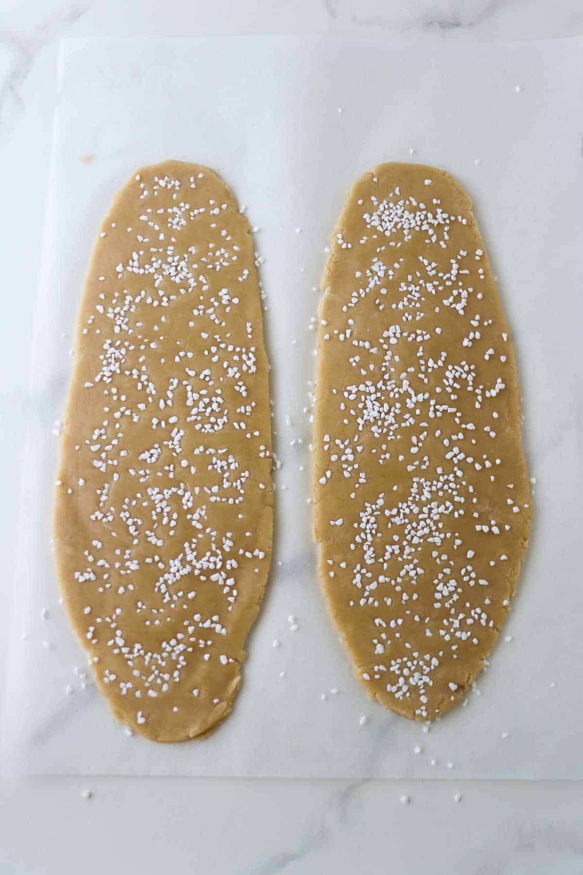 Kolasnittar dough rolled out and topped with pearl sugar.