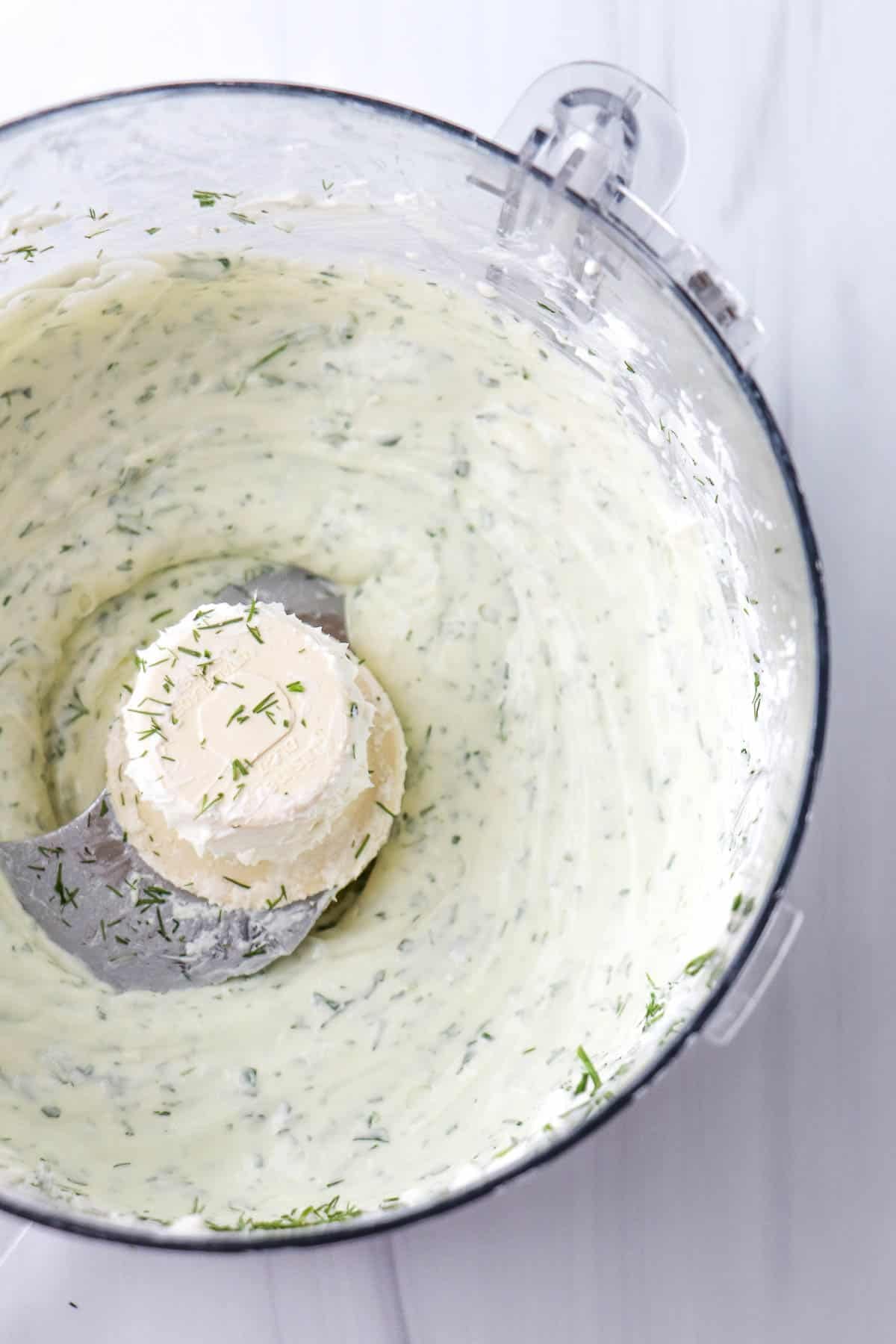 Herbed Whipped Goat Cheese in a food processor bowl.