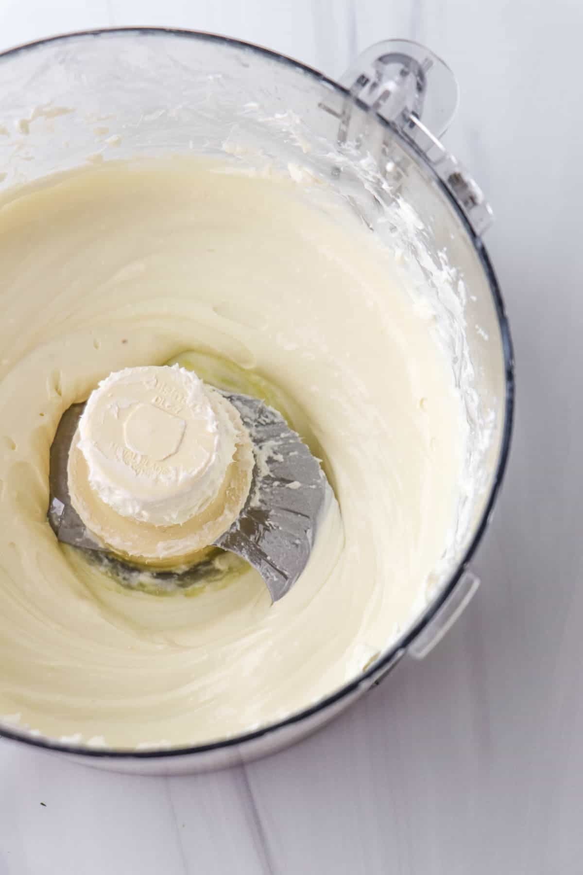 Whipped Goat Cheese in a food processor bowl.