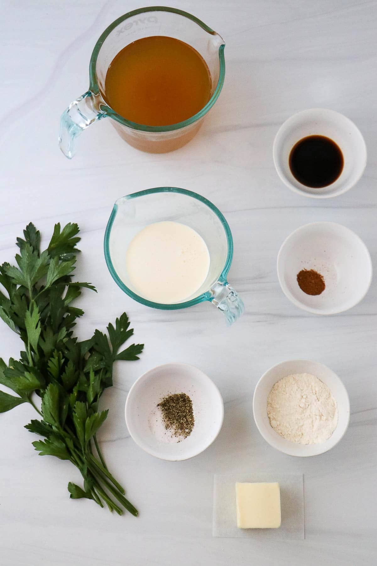 Ingredients needed for Swedish meatball sauce: broth, cream, soy sauce, nutmeg, salt and pepper, flour, butter and parsley.