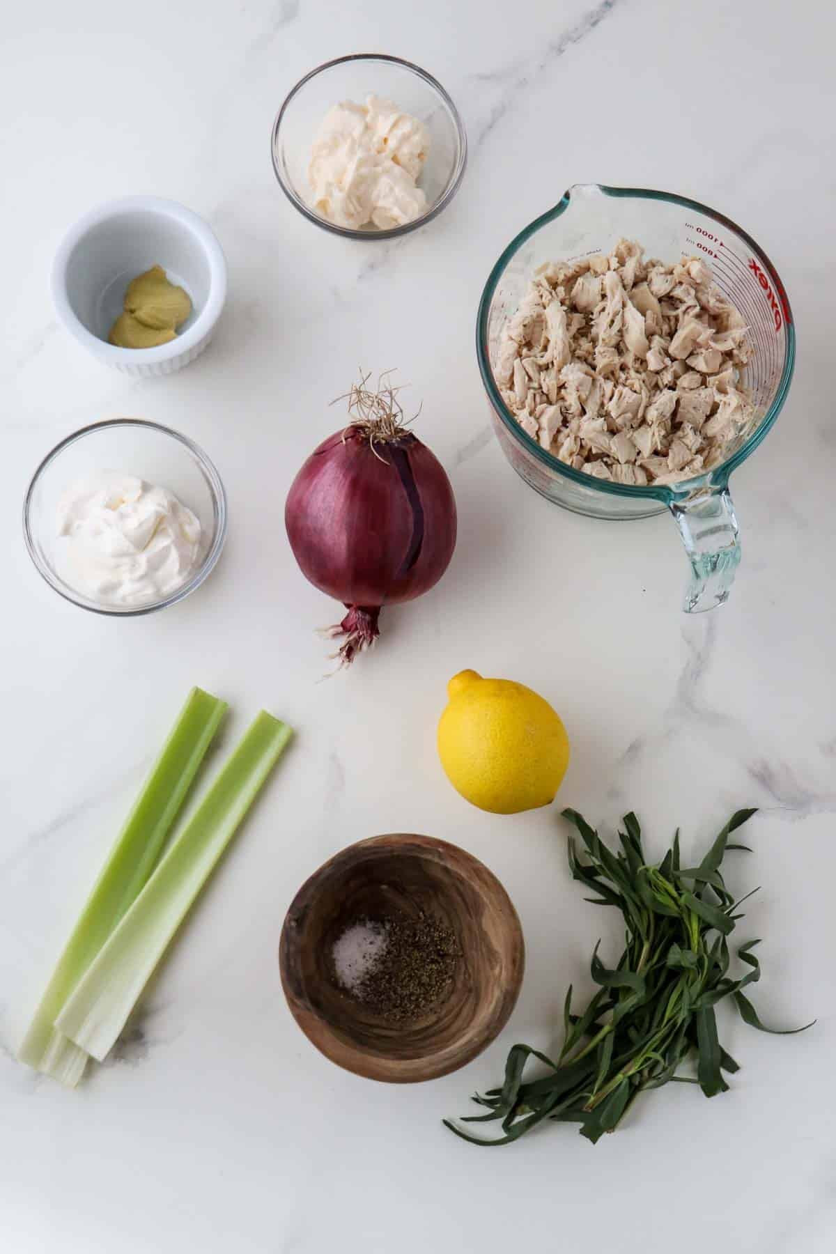 Ingredients for Creamy Tarragon Chicken Salad: Cooked chicken, mayonnaise, creme fraiche, mustard, red onion, lemon, celery, fresh tarragon and salt and pepper.