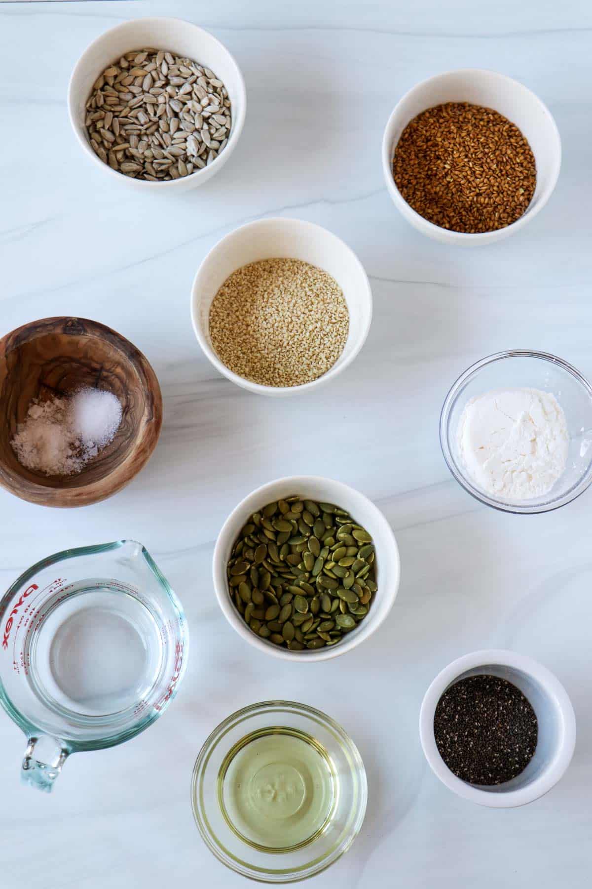 Ingredients needed for Gluten-Free Seed Crackers (Norwegian Crispbread): pumpkin, flax, sesame, sunflower and chia seeds, salt, cornstarch, vegetable oil and water.